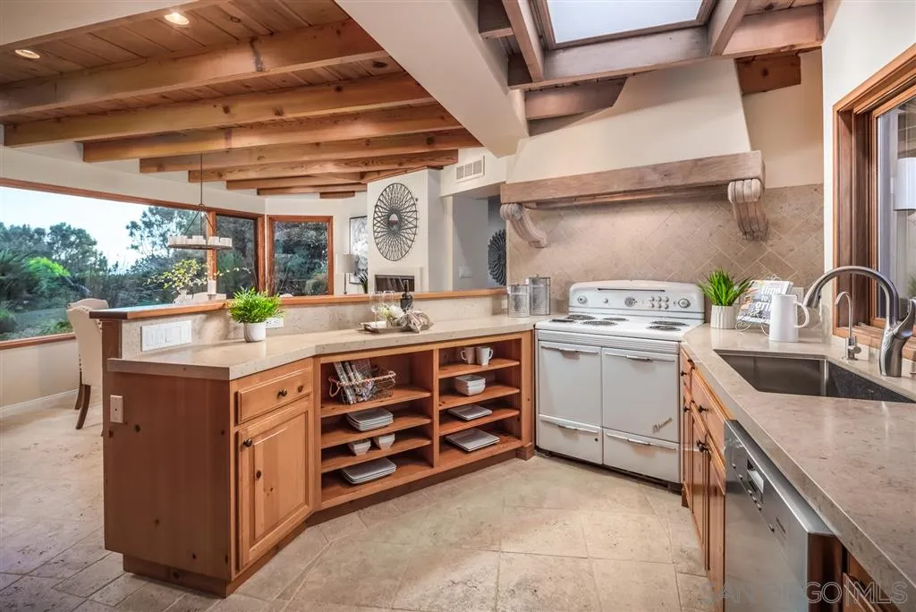 945 Crest Road Del Mar, CA 92014 - Photo 4 of 23 a utility room with cabinets dryer and washer