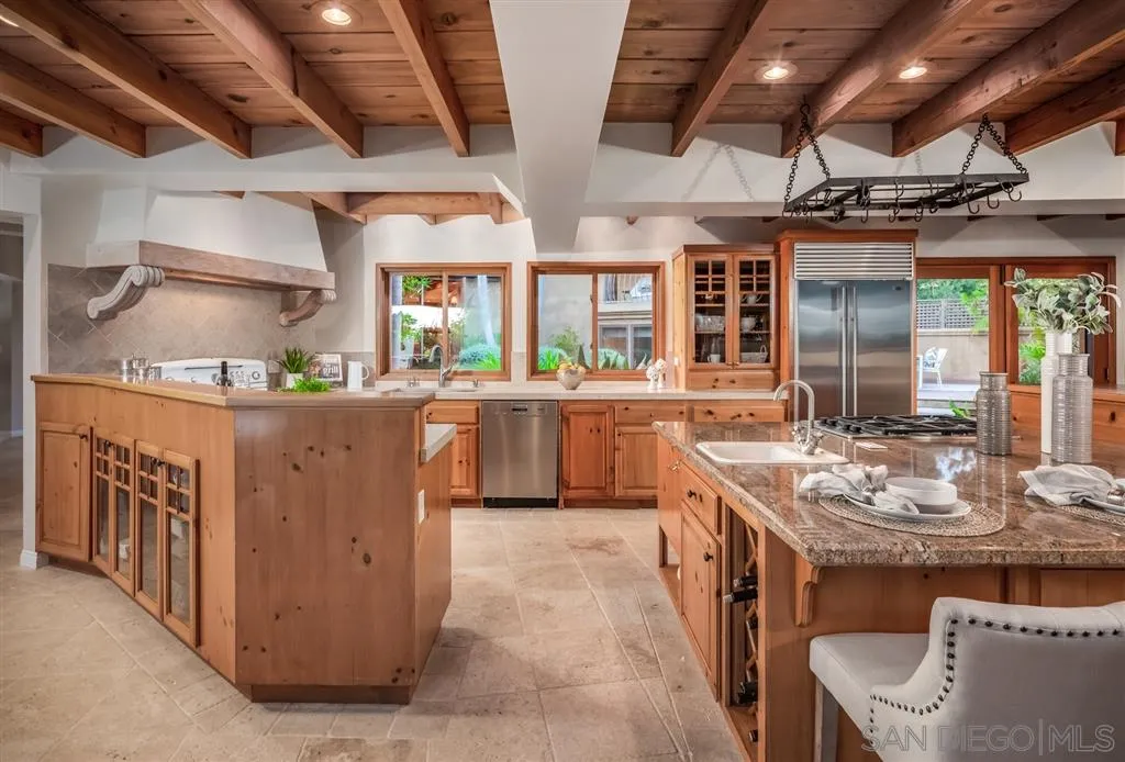 945 Crest Road Del Mar, CA 92014 - Photo 5 of 23 a kitchen with sink stove and cabinets