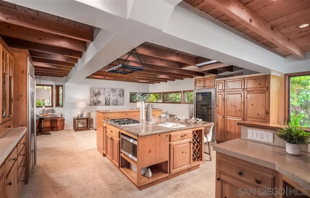 945 Crest Road Del Mar, CA 92014 - Photo 6 of 23 a utility room with stainless steel appliances granite countertop a stove a sink and a refrigerator