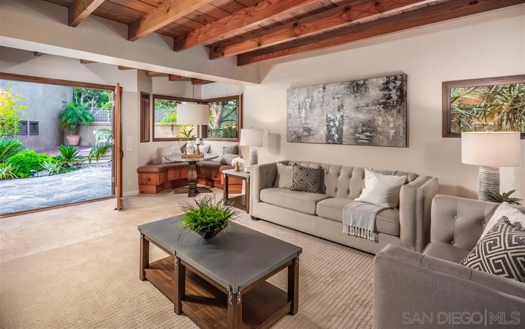 945 Crest Road Del Mar, CA 92014 - Photo 8 of 23 a living room with furniture plant and a large window