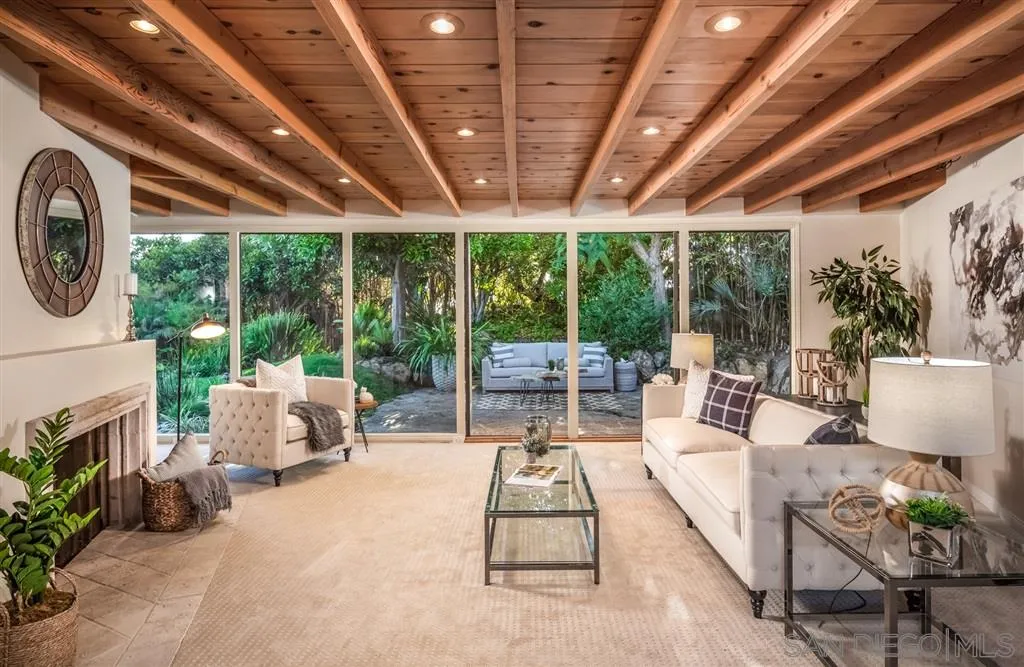 945 Crest Road Del Mar, CA 92014 - Photo 9 of 23 a living room with furniture and a large window