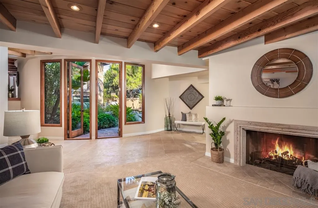 945 Crest Road Del Mar, CA 92014 - Photo 10 of 23 a living room with furniture a fireplace and a large window