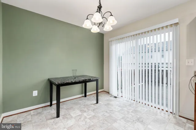 a view of a chandelier fan and entryway