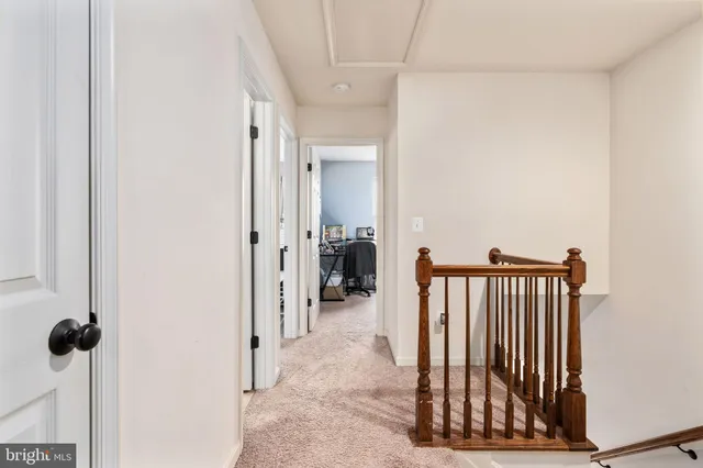 a view of a hallway with a door and stairs