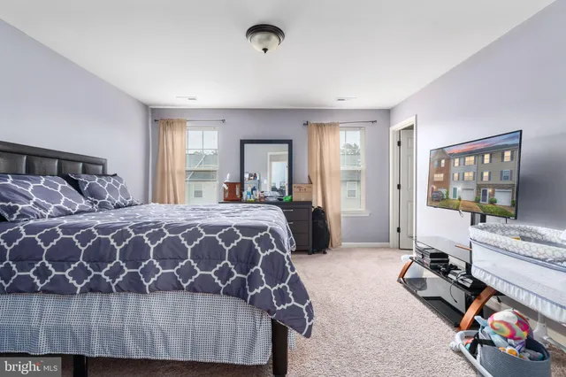 a bedroom with a bed and a large mirror