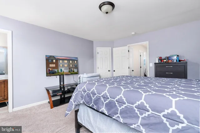 a bedroom with a bed and a desk