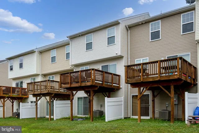 a front view of a house with a garden and deck