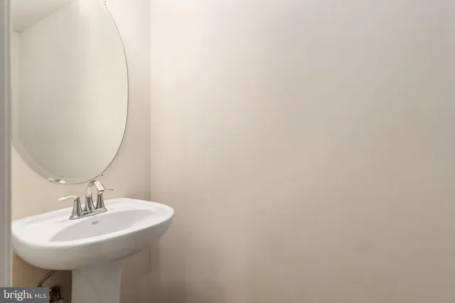 a bathroom with a sink a mirror and a toilet
