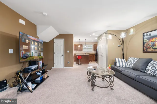 a living room with furniture gym equipment and a large window