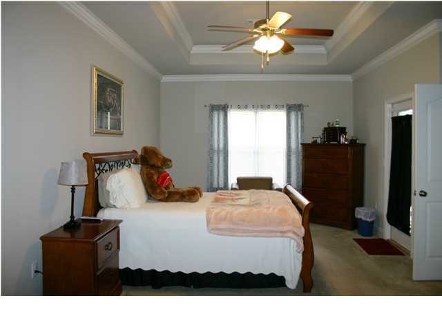 658 Red Fern Road Crestview, FL 32536 - Photo 11 of 20 a bedroom with a bed and a chandelier