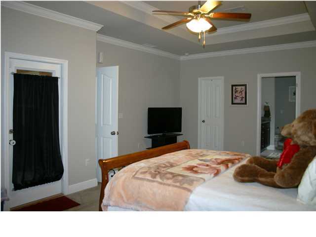658 Red Fern Road Crestview, FL 32536 - Photo 12 of 20 a bedroom with a bed and a chandelier