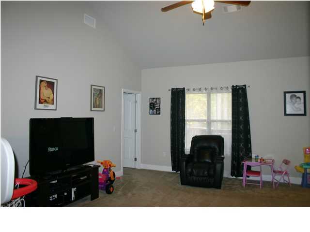 658 Red Fern Road Crestview, FL 32536 - Photo 3 of 20 a living room with furniture flat screen tv and a fireplace