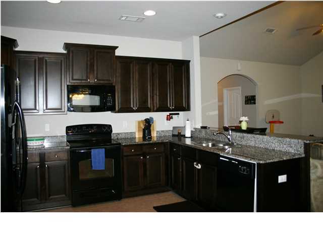 658 Red Fern Road Crestview, FL 32536 - Photo 5 of 20 a kitchen with a sink stainless steel appliances and cabinets