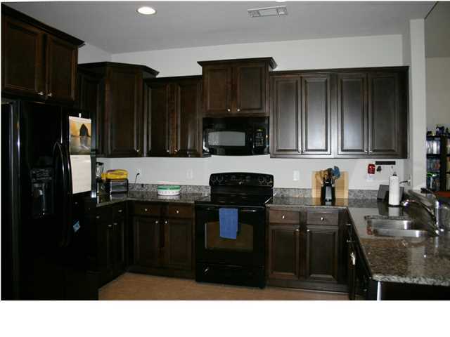 658 Red Fern Road Crestview, FL 32536 - Photo 7 of 20 a kitchen with a refrigerator and stove