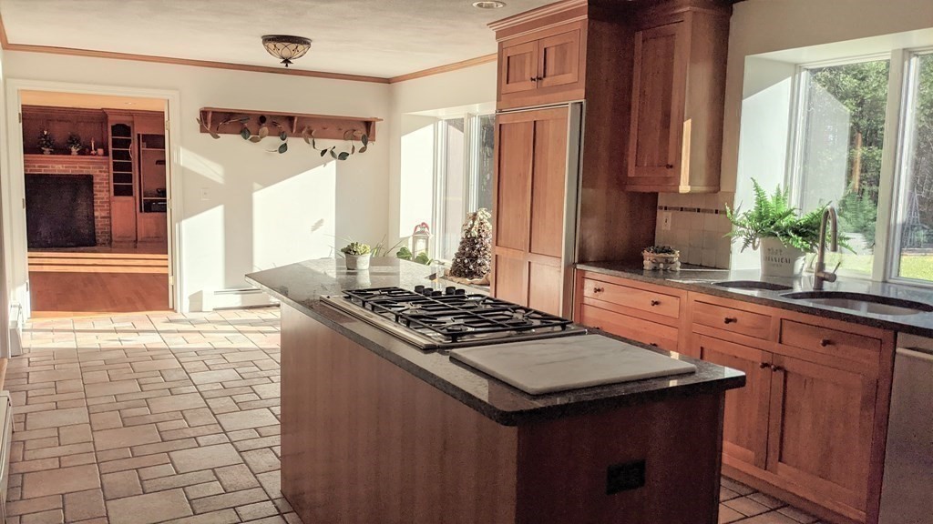 92 Lyman Road Berlin, MA 01503 - Photo 17 of 32 a kitchen with a stove a sink and a cabinets