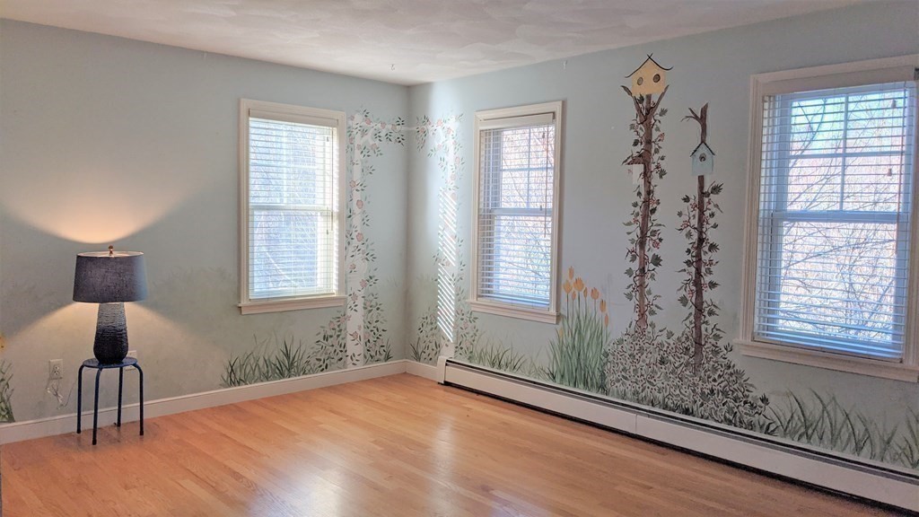 92 Lyman Road Berlin, MA 01503 - Photo 23 of 32 a view of an empty room with a window and wooden floor