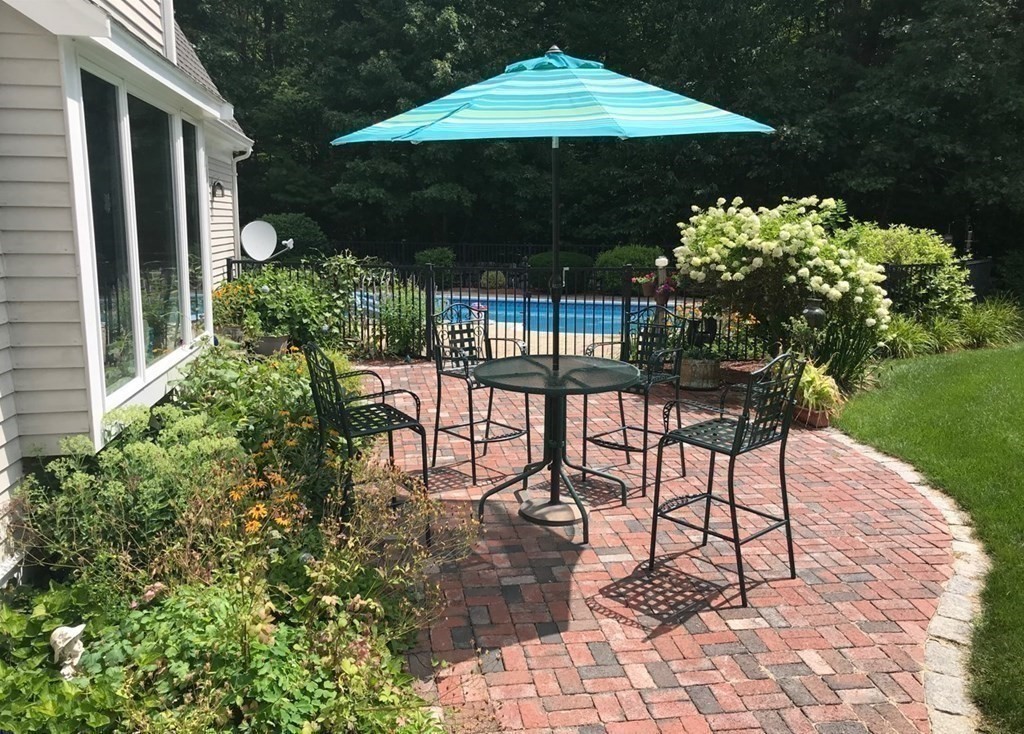 92 Lyman Road Berlin, MA 01503 - Photo 3 of 32 a patio with a patio table and chairs