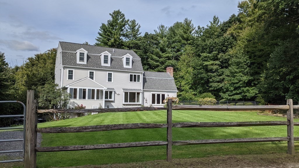 92 Lyman Road Berlin, MA 01503 - Photo 6 of 32 a front view of a house with a yard