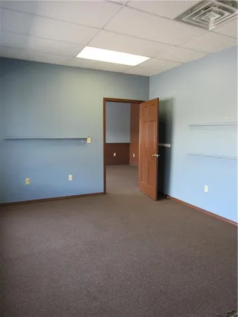 a view of an empty room with a kitchen