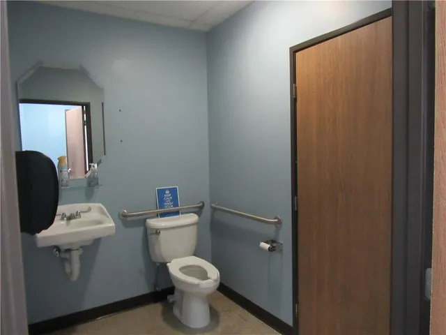 a white toilet sitting next to a bathroom sink