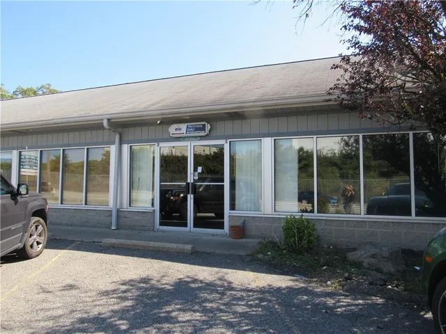 a view of a brick house with large windows