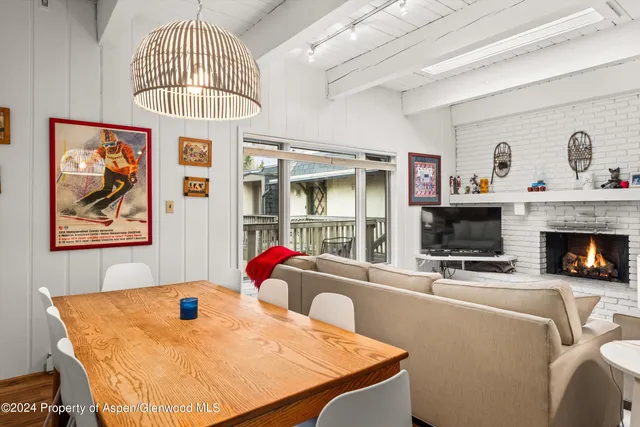 a living room with furniture a chandelier and a fireplace