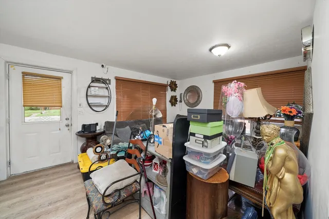 a dining room filled with furniture and a window