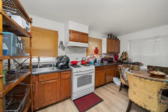 a kitchen with stainless steel appliances granite countertop a stove sink and cabinets