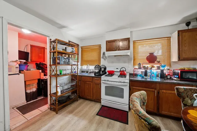 a kitchen with granite countertop a stove and chairs