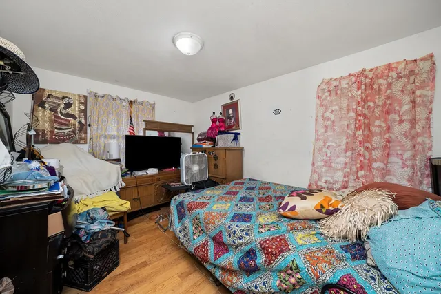 a bedroom with bed and a couch