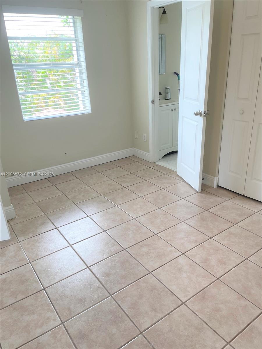 5116 Southwest 57th Avenue, Unit B Miami, FL 33155 - Photo 13 of 26 a view of an empty room and a window