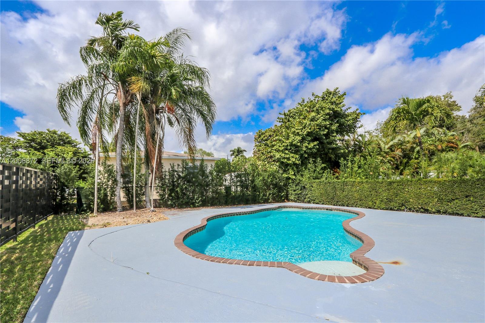 5116 Southwest 57th Avenue, Unit B Miami, FL 33155 - Photo 19 of 26 a view of a swimming pool and a yard
