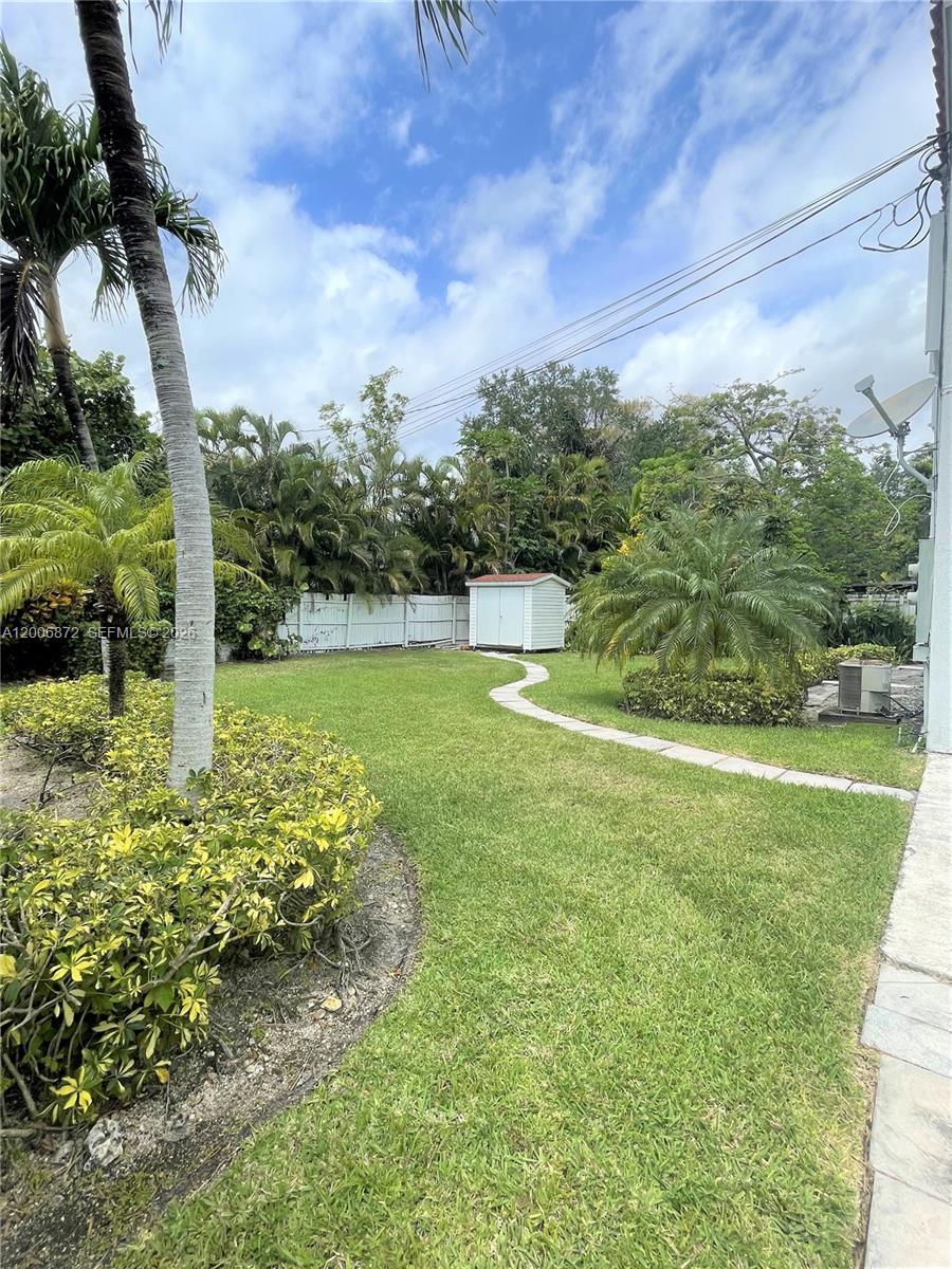 5116 Southwest 57th Avenue, Unit B Miami, FL 33155 - Photo 7 of 26 a view of a garden with a building in the background