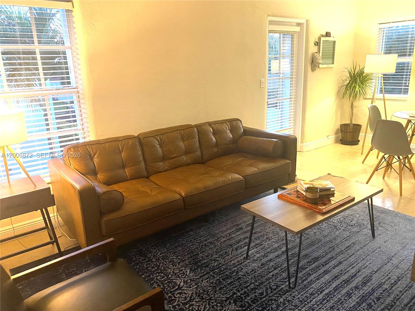 5116 Southwest 57th Avenue, Unit B Miami, FL 33155 - Photo 9 of 26 a living room with furniture and a window