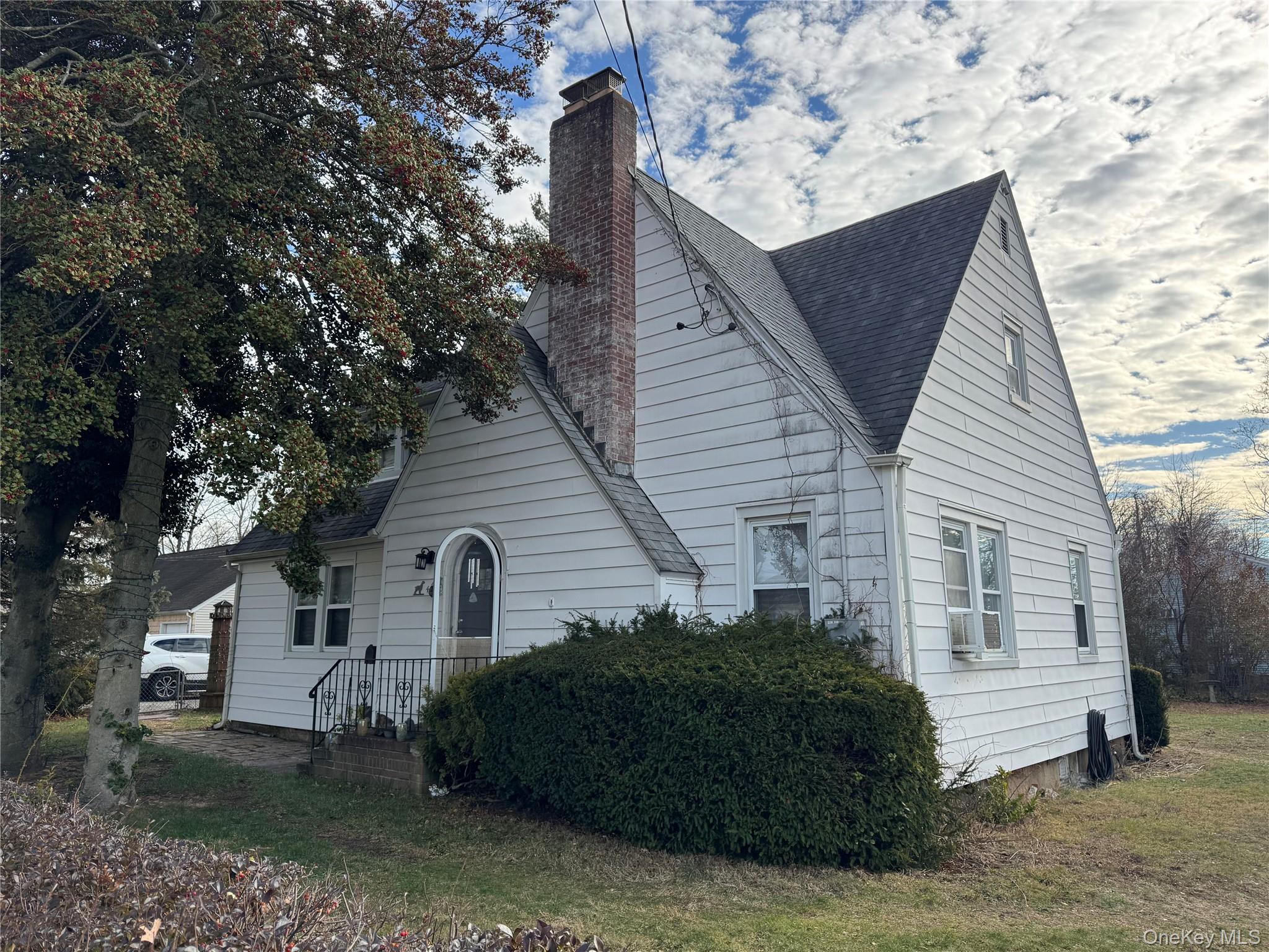 42 Greenwood Road Bay Shore, NY 11706 - Photo 1 of 1 a front view of a house with a garden