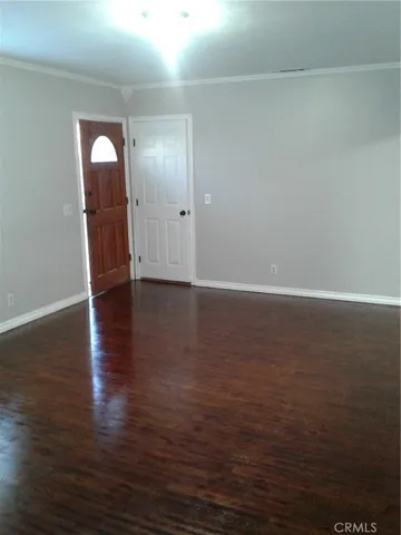a view of a room with wooden floor