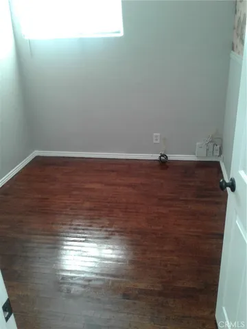 a view of a room with an empty space and a window