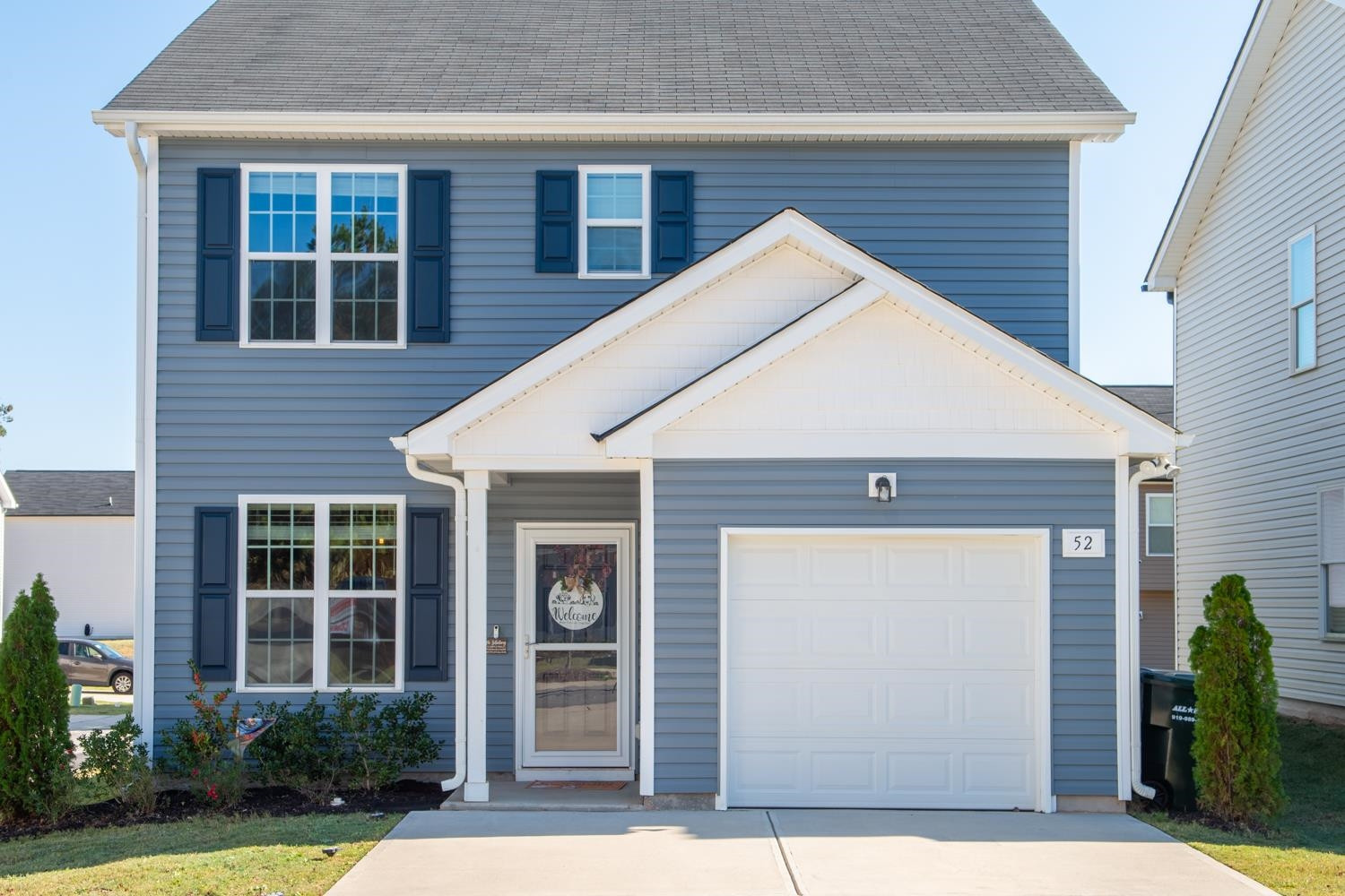 52 Principal Way Clayton, NC 27520 - Photo 2 of 31 a view of brick house with potted plants