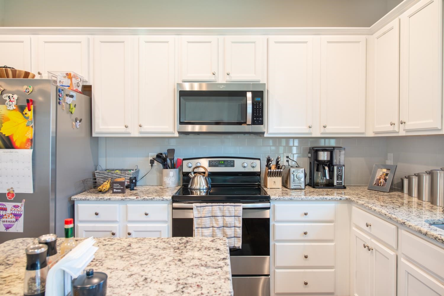 52 Principal Way Clayton, NC 27520 - Photo 7 of 31 a kitchen with stainless steel appliances granite countertop a stove a sink and a microwave