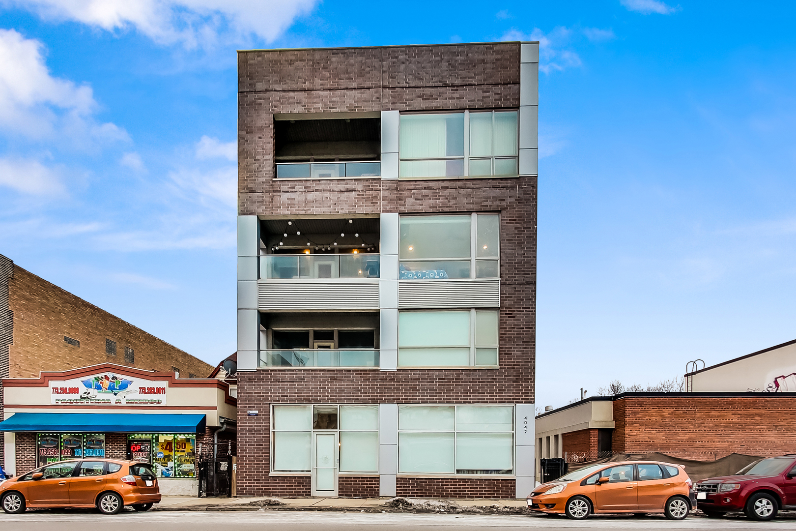 4042 North Pulaski Road, Unit 3W Chicago, IL 60641 - Photo 1 of 33 a front view of a building with parking