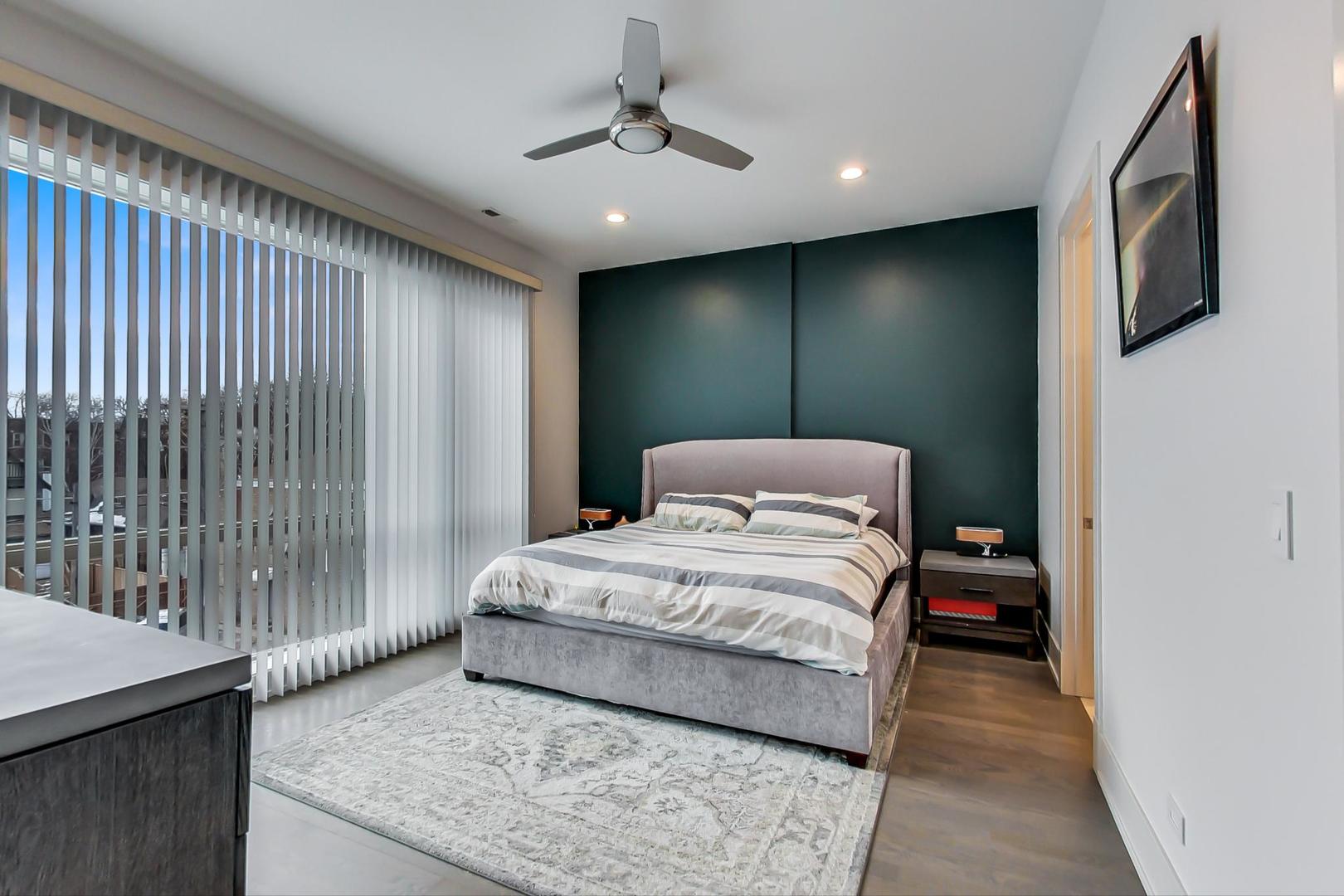 4042 North Pulaski Road, Unit 3W Chicago, IL 60641 - Photo 12 of 33 a bedroom with a bed and a chandelier