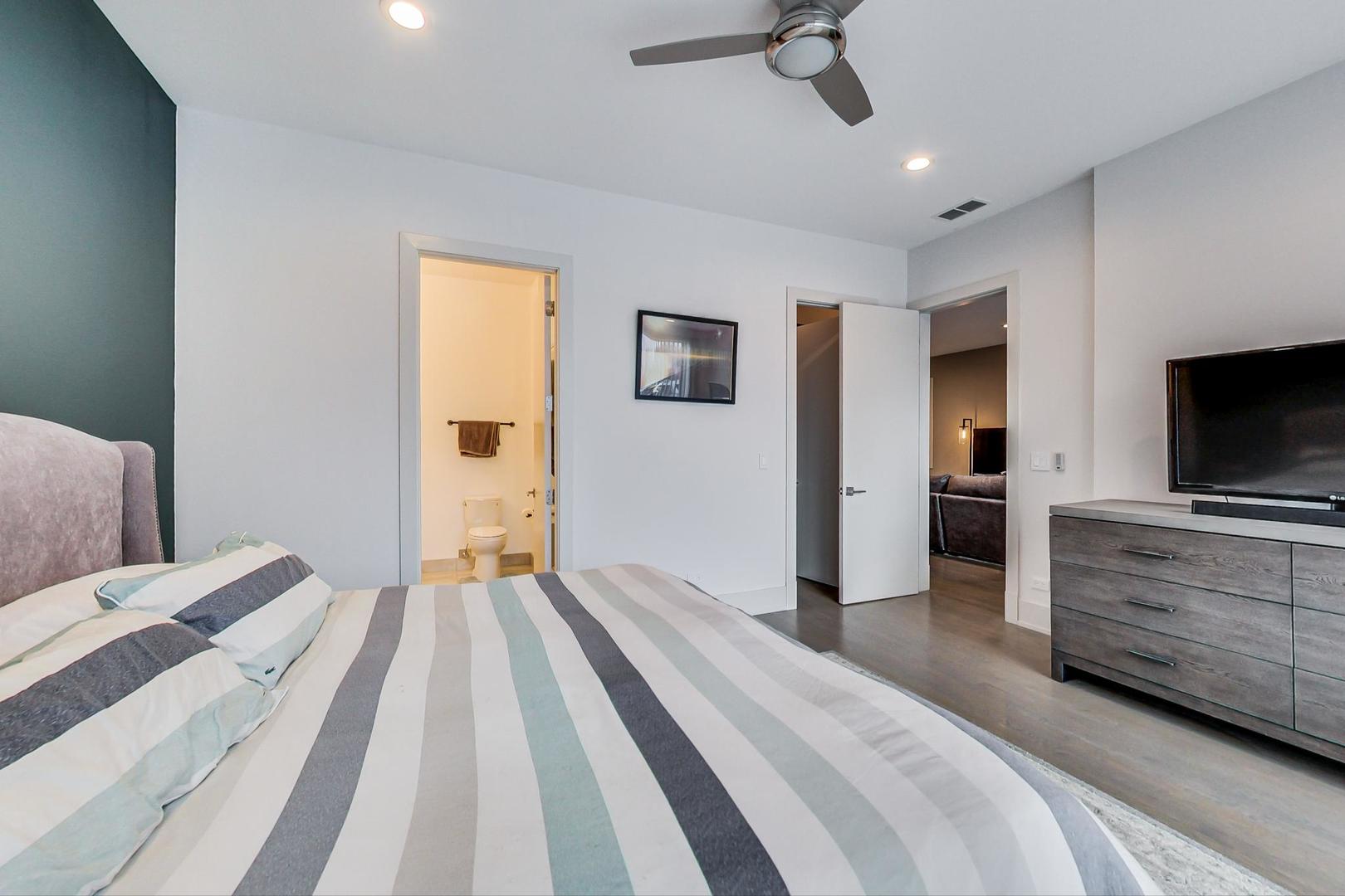 4042 North Pulaski Road, Unit 3W Chicago, IL 60641 - Photo 14 of 33 a bedroom with a bed and a flat screen tv