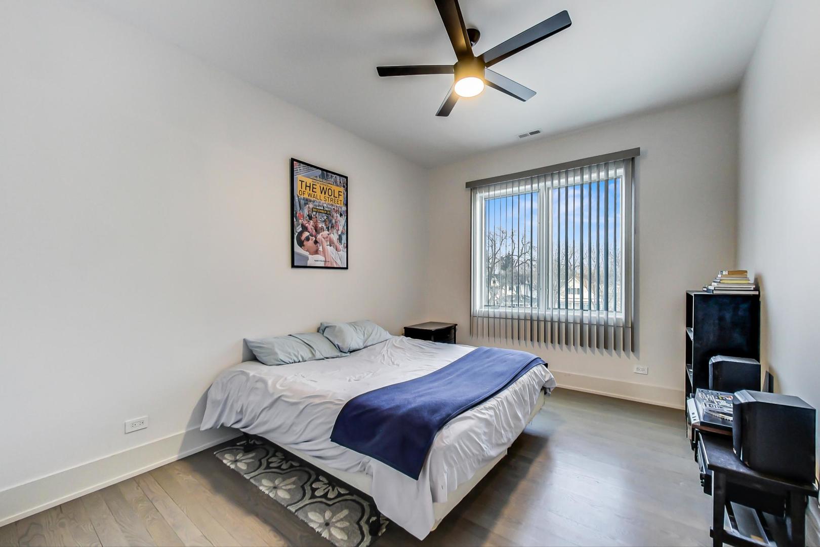 4042 North Pulaski Road, Unit 3W Chicago, IL 60641 - Photo 18 of 33 a bedroom with a bed and wooden floor