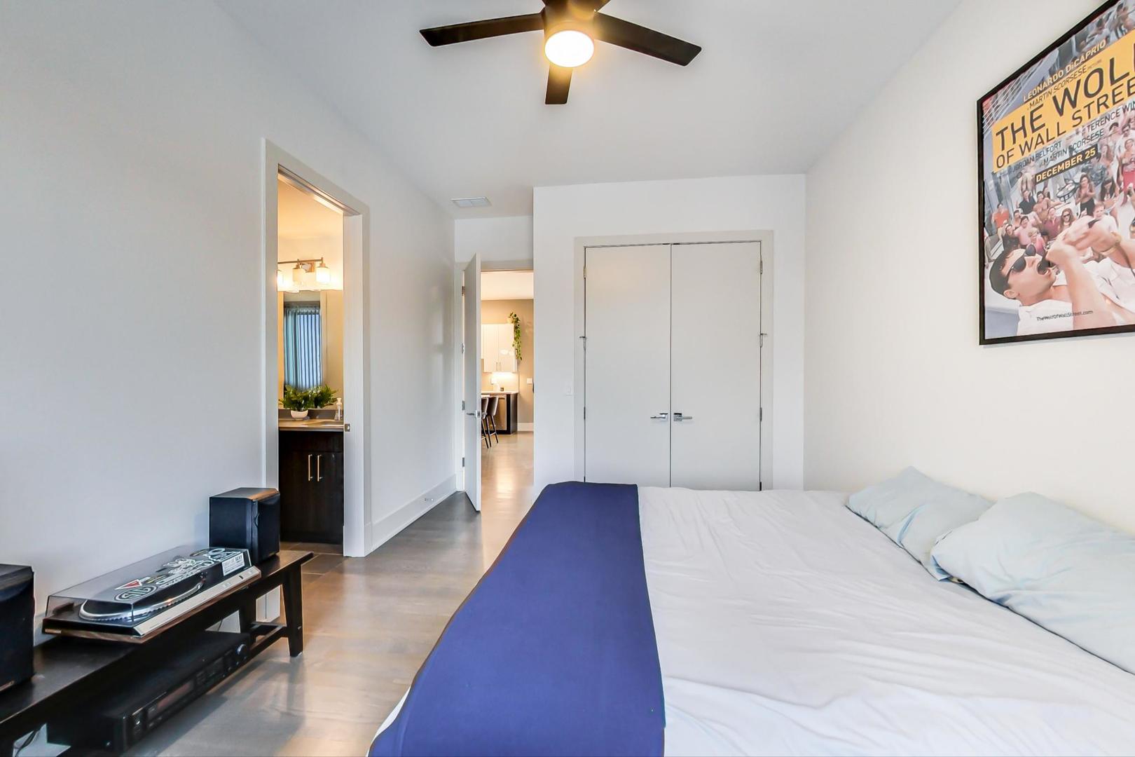 4042 North Pulaski Road, Unit 3W Chicago, IL 60641 - Photo 20 of 33 a spacious bedroom with a bed and a chandelier