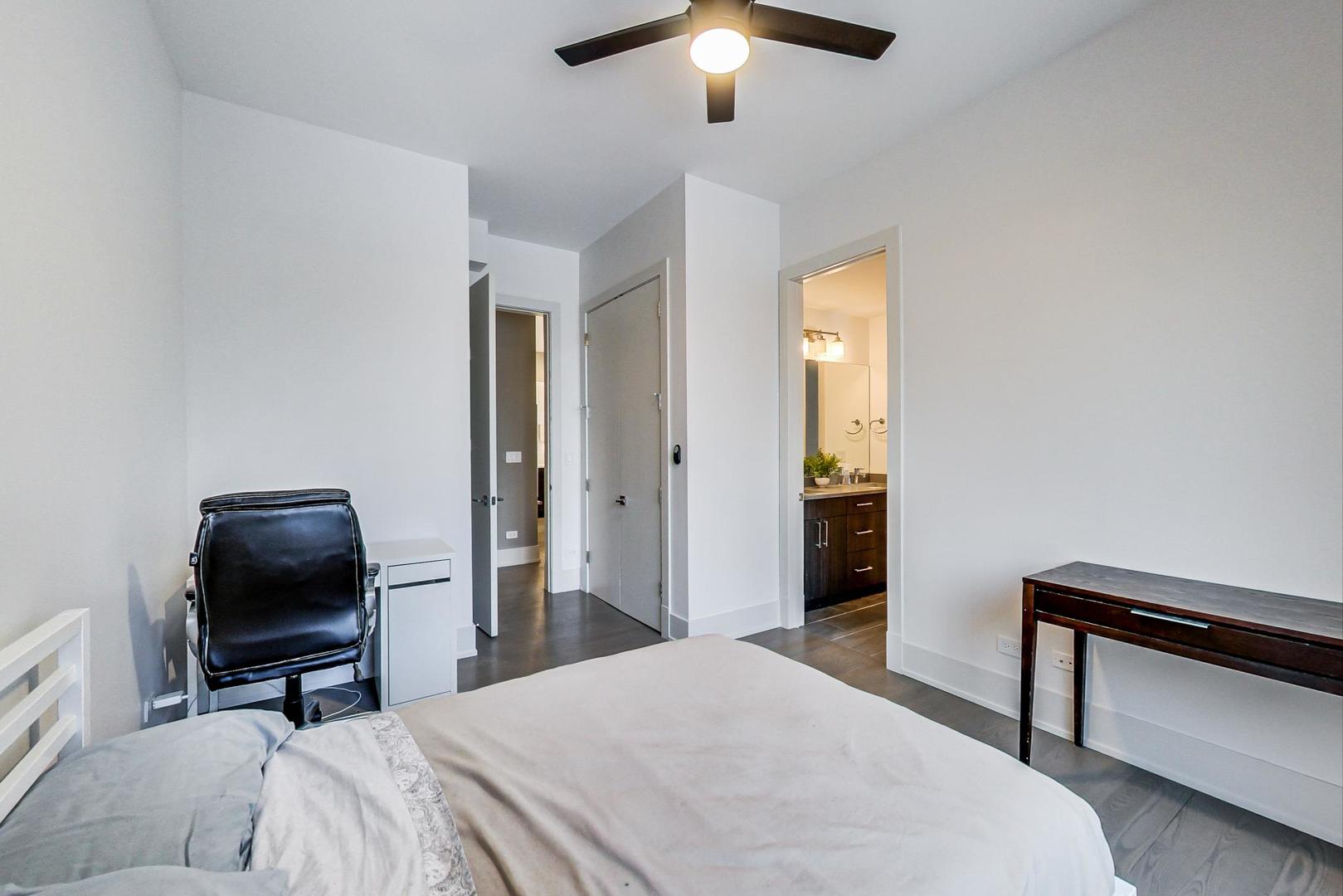 4042 North Pulaski Road, Unit 3W Chicago, IL 60641 - Photo 21 of 33 a bedroom with a bed and a chair