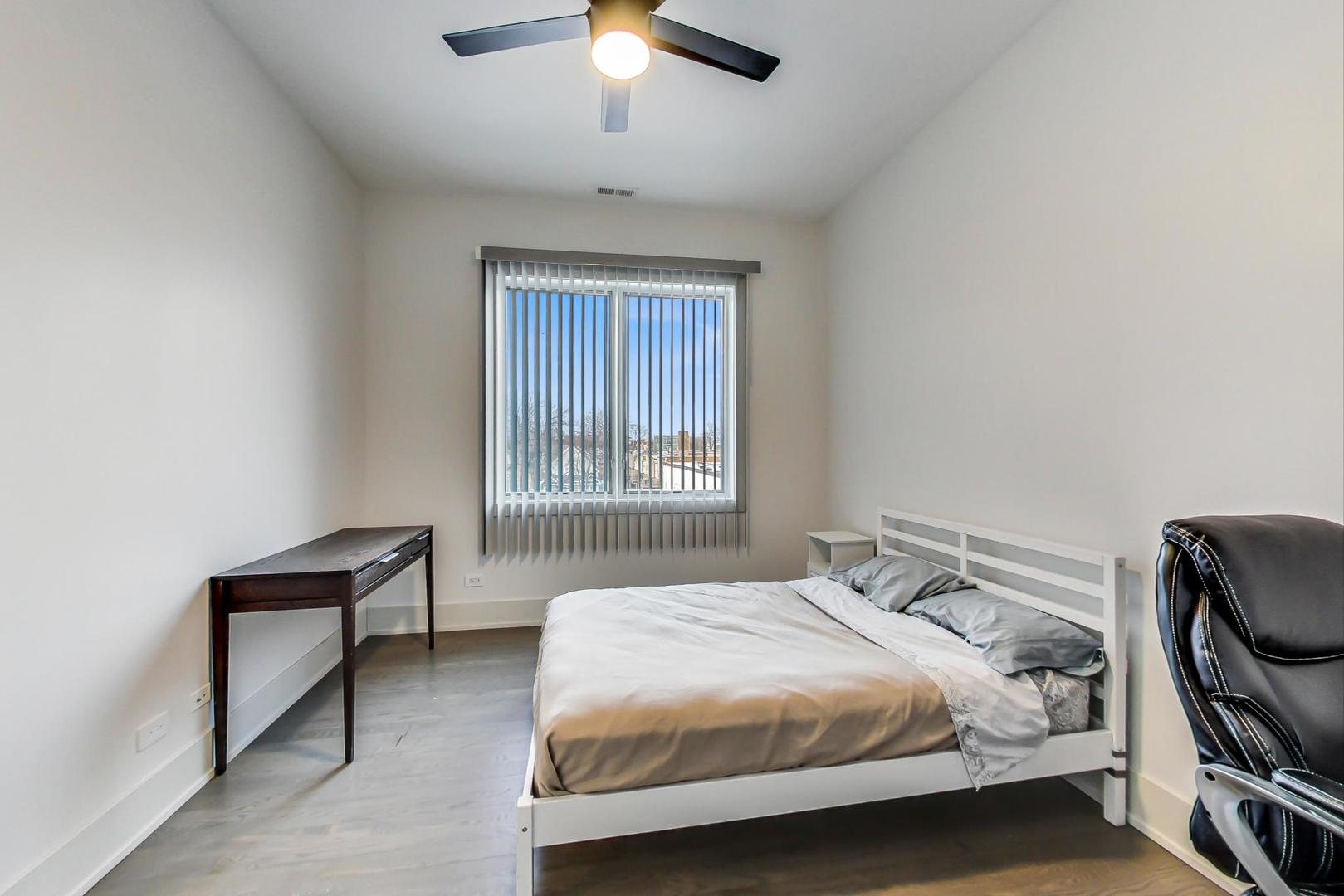 4042 North Pulaski Road, Unit 3W Chicago, IL 60641 - Photo 22 of 33 a bedroom with a bed and a window