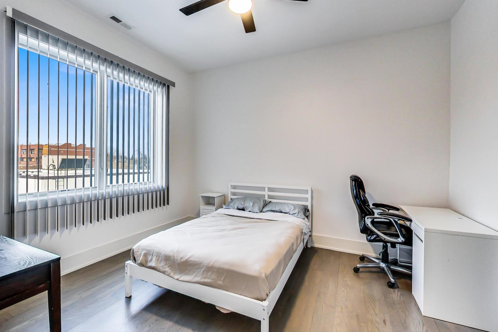 4042 North Pulaski Road, Unit 3W Chicago, IL 60641 - Photo 23 of 33 a bedroom with a bed and a chair
