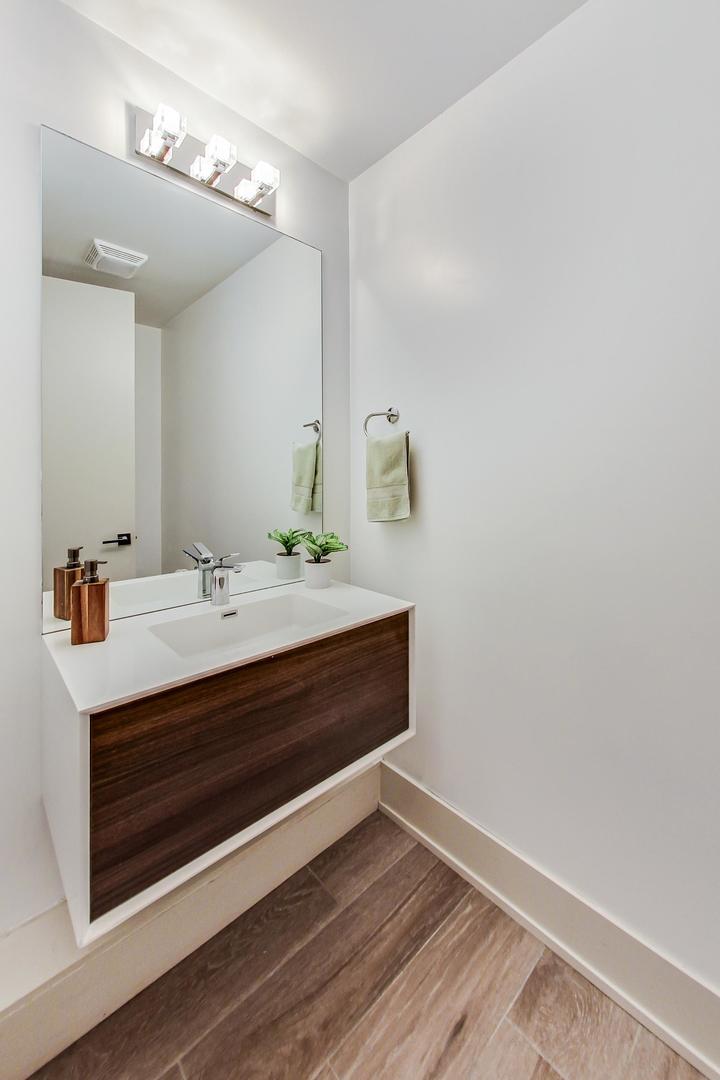 4042 North Pulaski Road, Unit 3W Chicago, IL 60641 - Photo 27 of 33 a bathroom with a sink and a mirror