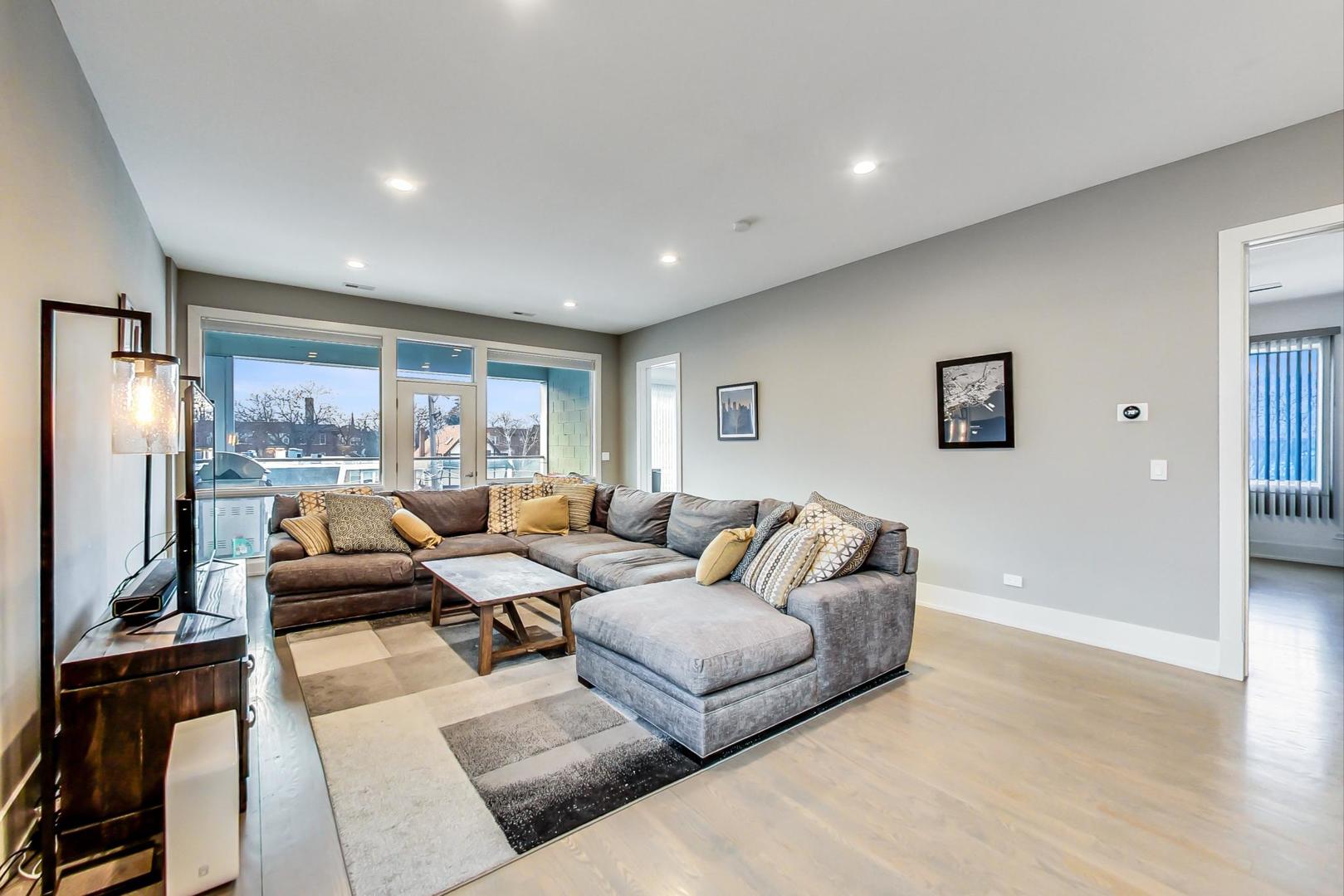 4042 North Pulaski Road, Unit 3W Chicago, IL 60641 - Photo 5 of 33 a living room with furniture window and a table