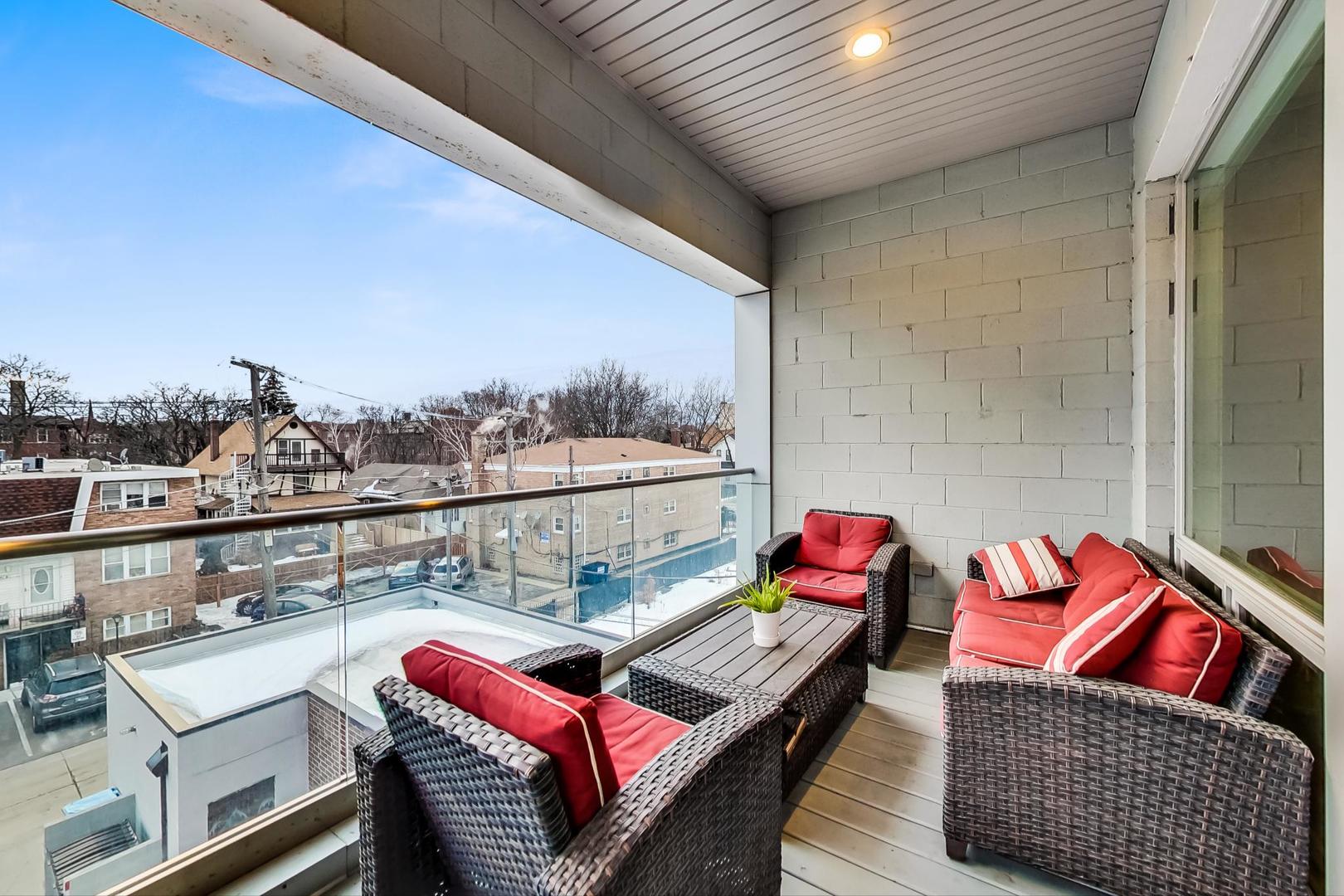 4042 North Pulaski Road, Unit 3W Chicago, IL 60641 - Photo 10 of 33 a roof deck with couch and wooden floor